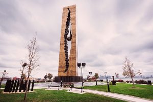 This monument sits on a the end of a penisula in Bayonne by the Cruise Port. It is a large 9-11 Memorial that is tall and rectangle with a crack in the middle and giant steel tear drop.