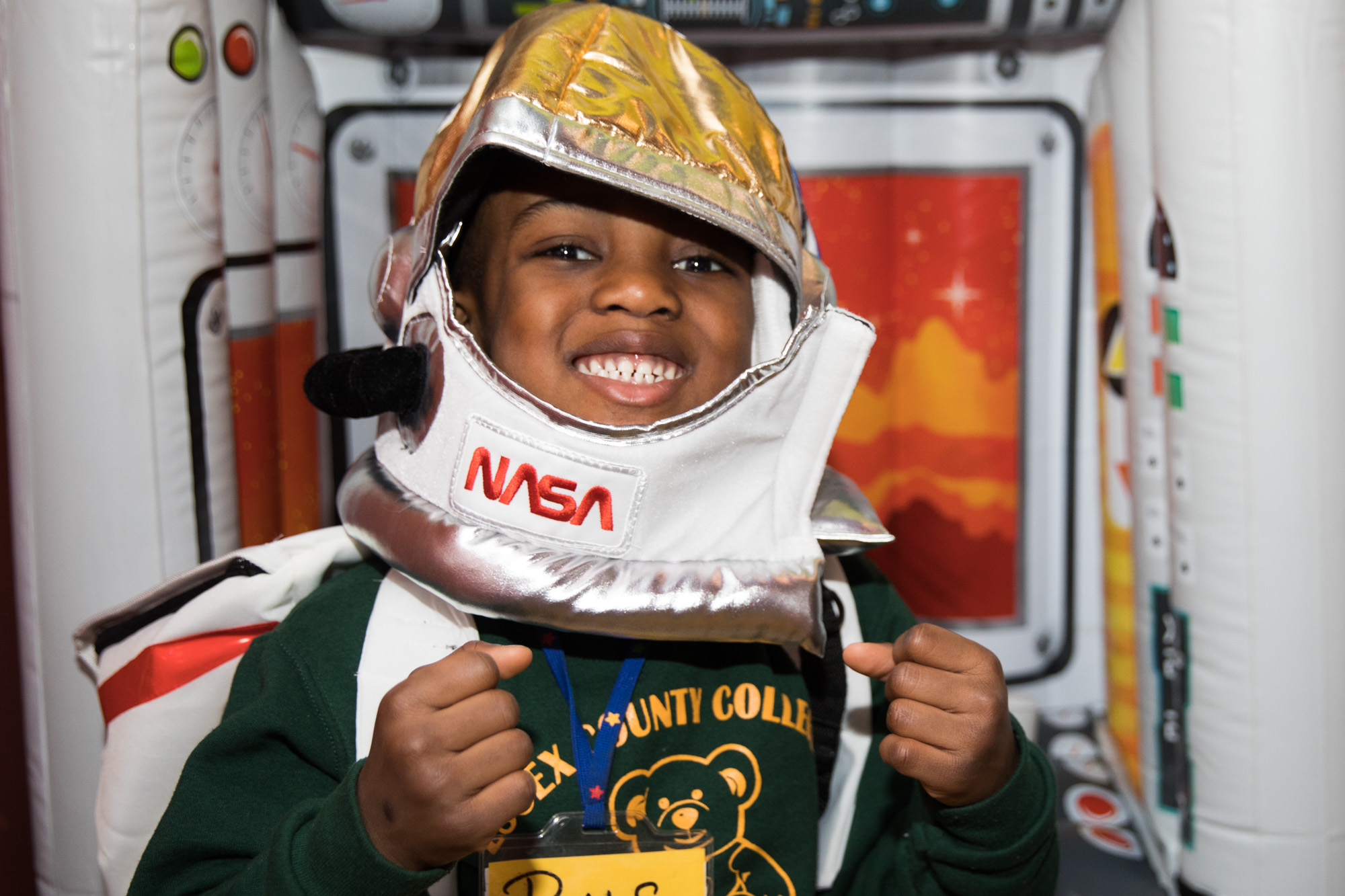 Young boy wearing a costume nasa astronaut helmet 
