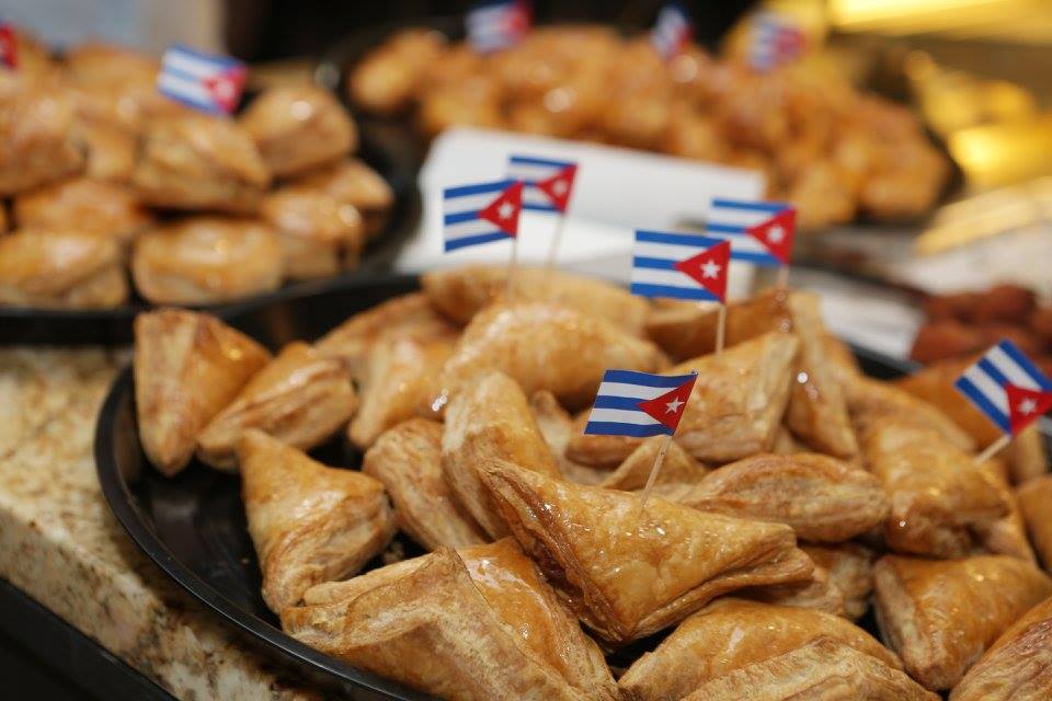 platters of small pastries with tiny Cuban flags on tooth picks inserted in them
