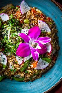 Avocado fried rice with flower garnish