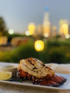 grilled lobster tail with a blurred background of NYC