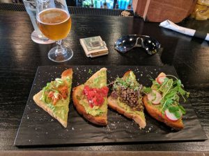 Slices of toast corners with veggie and avocado toppings 