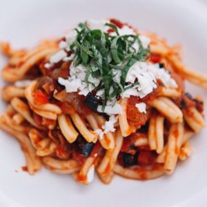 Spaghetti with tomato sauce topped with parmesan