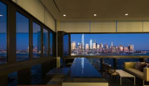 Hotel seating area with large windows looking out to a view of Manhattan