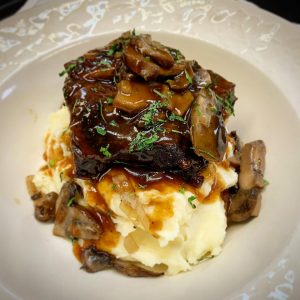 meat and mashed potato with a mushroom sauce