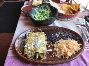 Plate of enchiladas and rice and beans