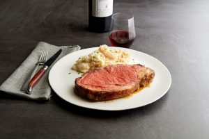 Steak and mashed potatoes with a glass of wine