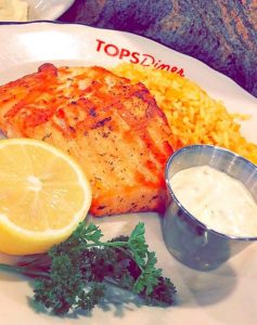 grilled piece if fish and yellow rice on a plate that says "Tops Diner" in red text