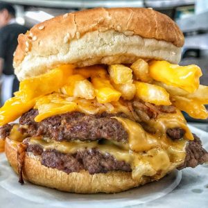 double cheeseburger with fries inside the burger