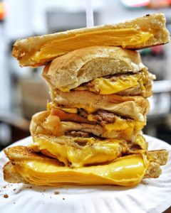 triple cheeseburger sandwiched between two grilled cheese sandwiches