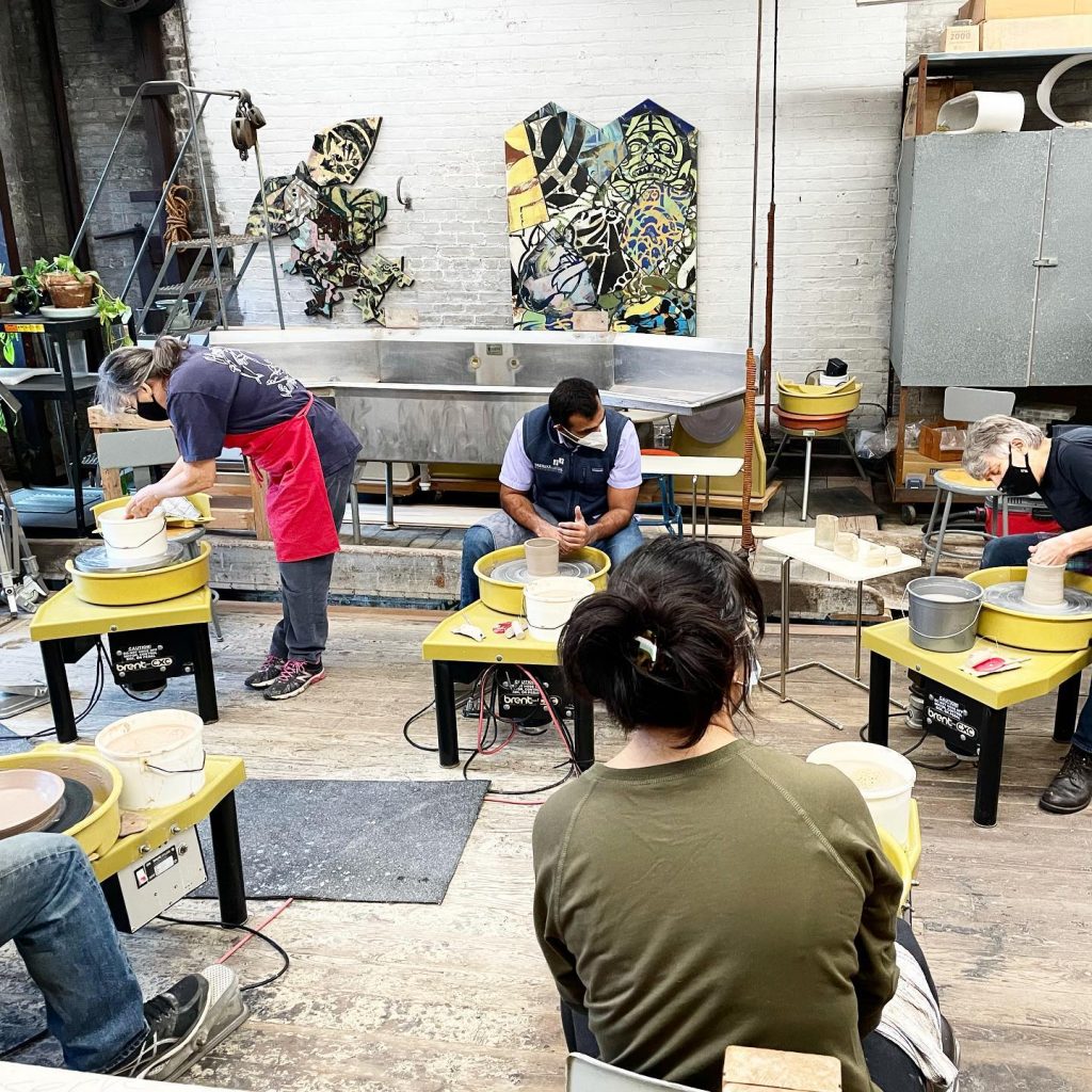 people doing pottery in a studio