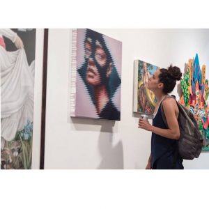 woman looking at art at gallery