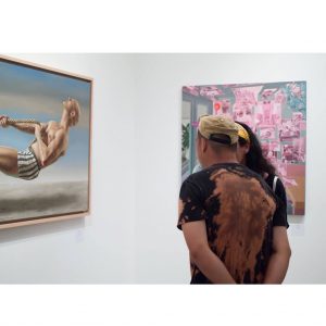 man and woman looking at art