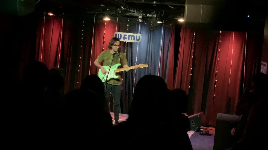 man playing guitar on stage