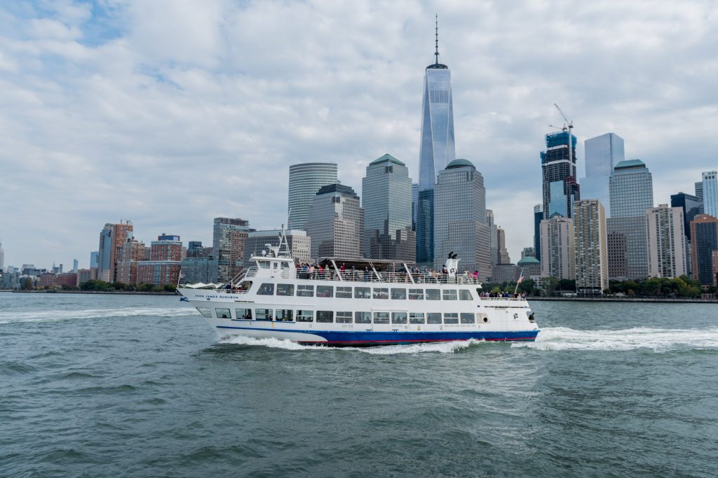 Ferry on the hudson river passing by new york city