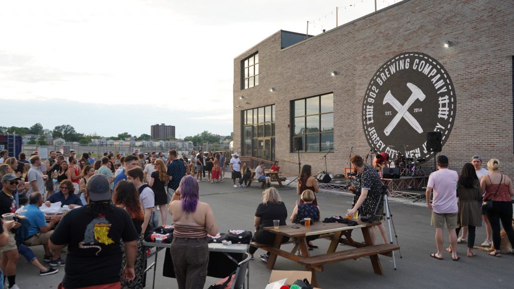 Crowd of patrons gather outside 902 Brewing Company in Jersey City, NJ