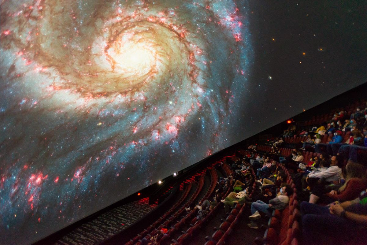 An image of an audience observing space from the Jennifer Chalsty Planetarium
