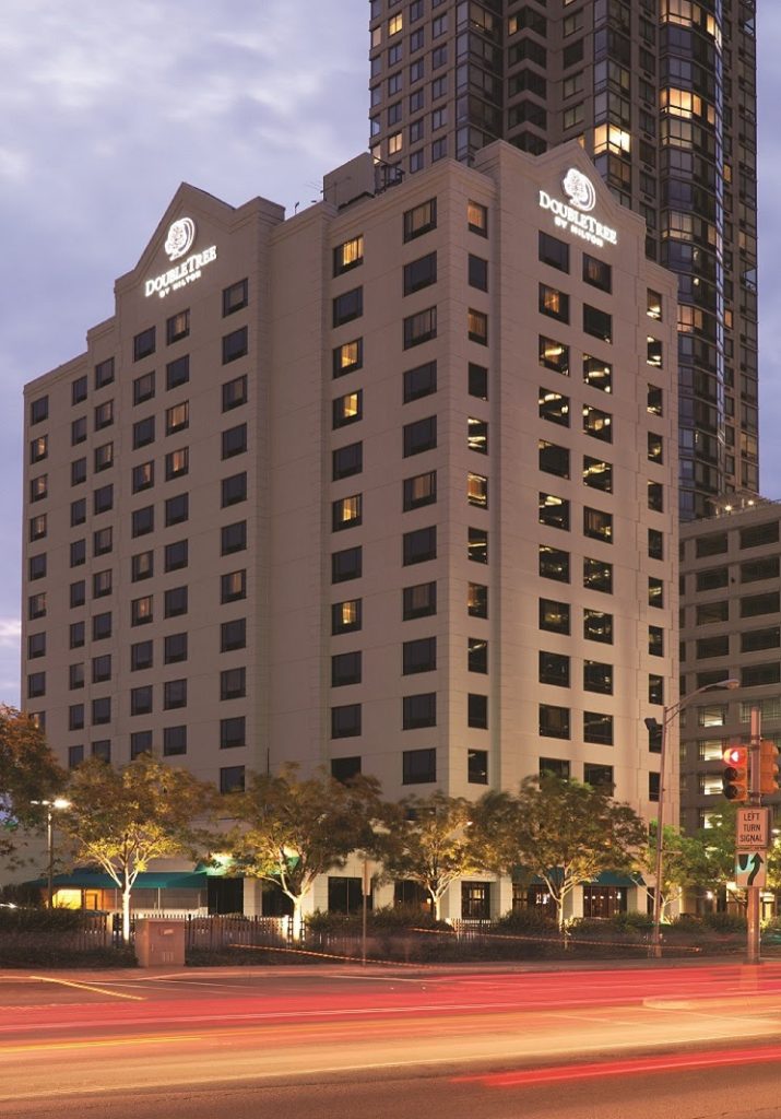 Exterior street view at dusk of the DoubleTree by Hilton Hotel & Suites in Jersey City, NJ