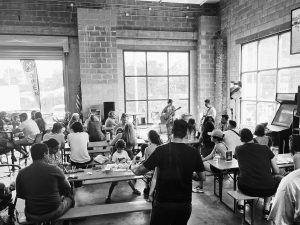 black and white photo of the inside of a busy brewery