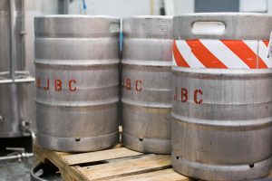 3 large silver canisters labeled "N.J.B.C."