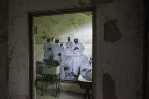 Old room of the ellis island Hospital complex that has a mural on the wall