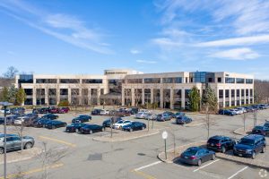 view of parking lot and large building