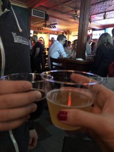 couple clinking their cocktails in the bar