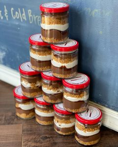 Tower of dessert jars; jars filled with layers cake or other type of dessert