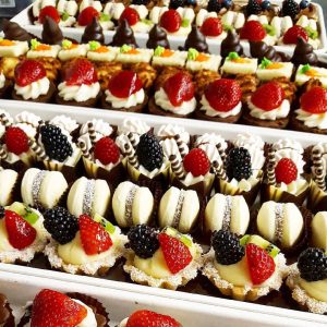 rows of different types of pastries and cakes