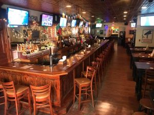 Inside Finnegan's pub; empty bar and seating area