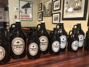 Various sizes of black jugs all with the Finnegan's Pub label