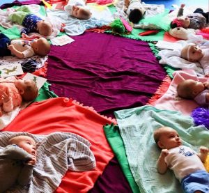 babies laying on blankets arranged in a circle 