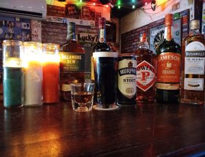 various beers and liquor bottles on a bar table