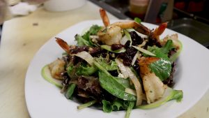 plate of spring salad with grilled shrimp