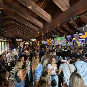 Inside the crowded McSwiggans Pub with multiple tvs playing sports games