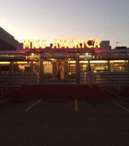 diner entrance with large neon letters on top spelling "Miss America"