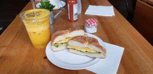 breakfast sandwich with a smoothie on a diner table