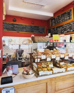 prato bakery counter with an area to pay and glass case filled with pastries