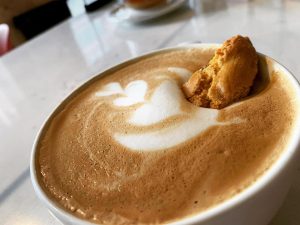 latte with a cookie dipped inside