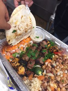 To go container with Mediterranean food from A1 Grill