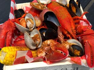 basket of seafood and corn on the cob