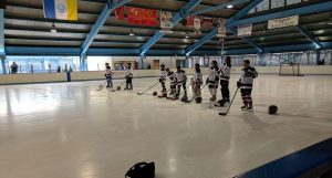 ice skating team lined up on rink