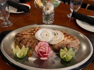 Plate of chicken plate with radish and lime sliced in a decorative manner 