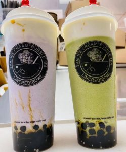 2 large cups of bubble tea, one purple and one green