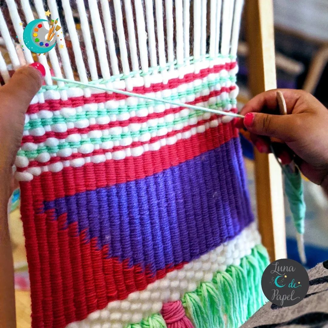 Photo of hands weaving thread