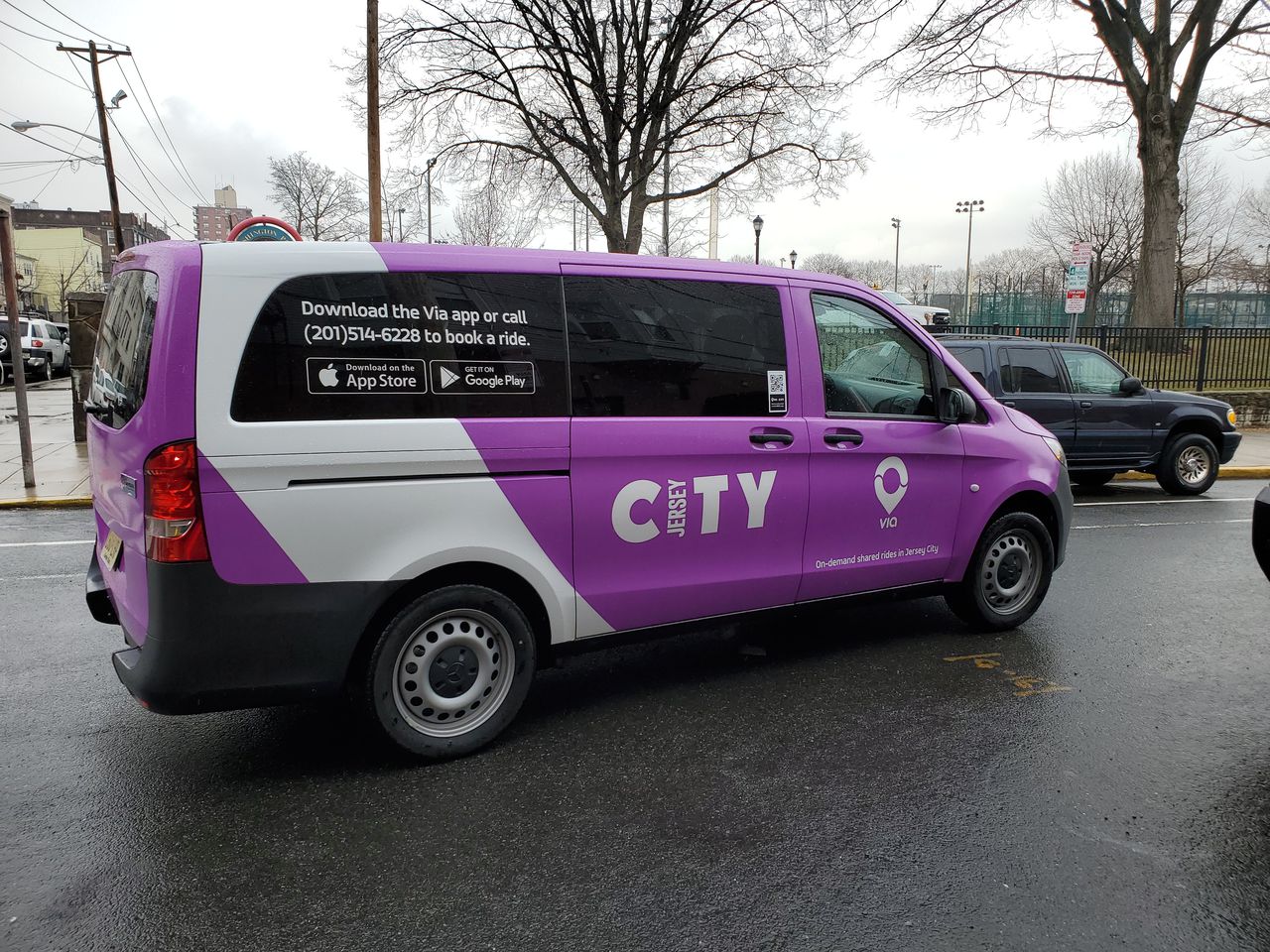 Purple van with the Jersey City logo on the side 