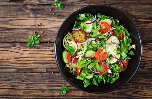 bowl of salad on a wood table