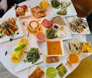 table full of various plates of food the cafe offers