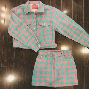 two-piece skirt and button down collared jacket top set in a pink and green pattern 