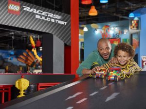 Father and son playing with lego race cars